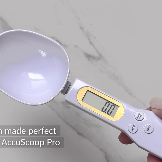 The AccuScoop Pro is shown accurately weighing and measuring 10 grams of protein powder. 